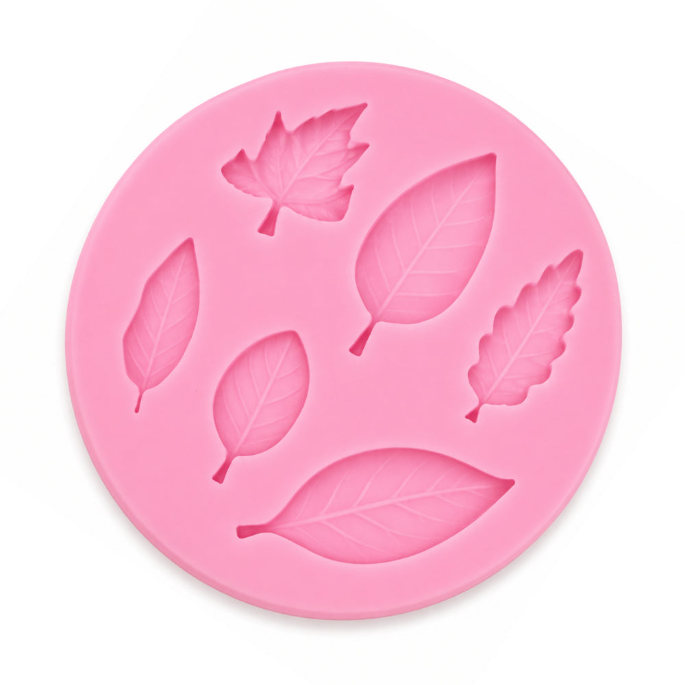 Pink silicone mold with leaf shapes on a white background