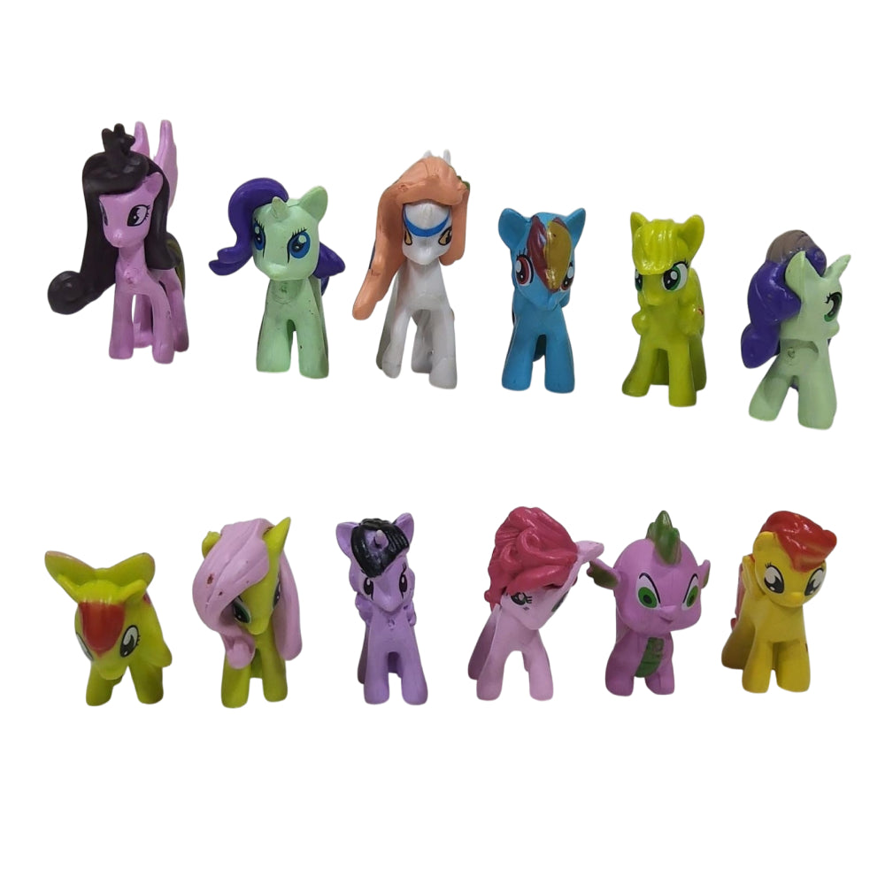 Collection of colorful toy ponies on a white background