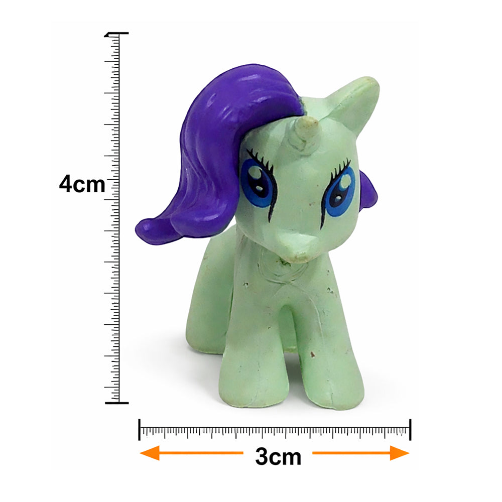 Small green unicorn figurine with purple hair next to measurement scales on a white background