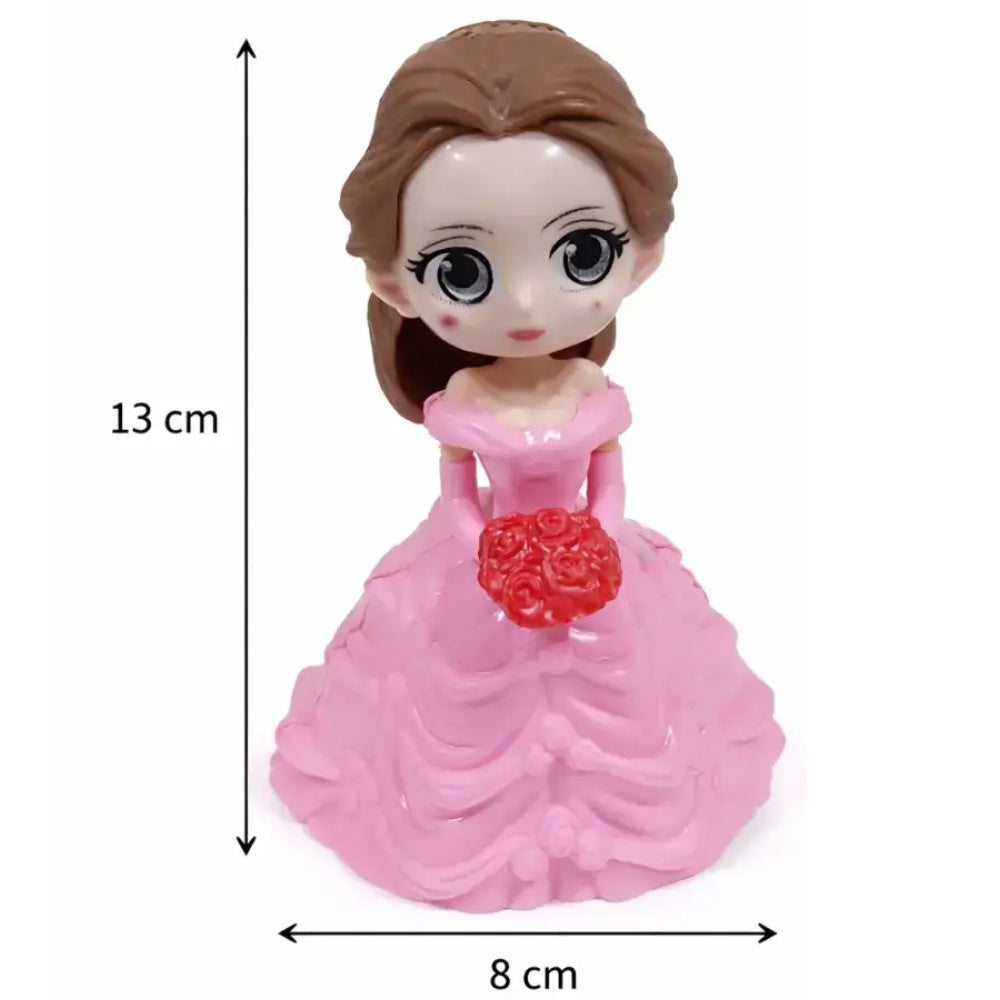 Toy figure of a girl in a pink dress with measurements on a white background