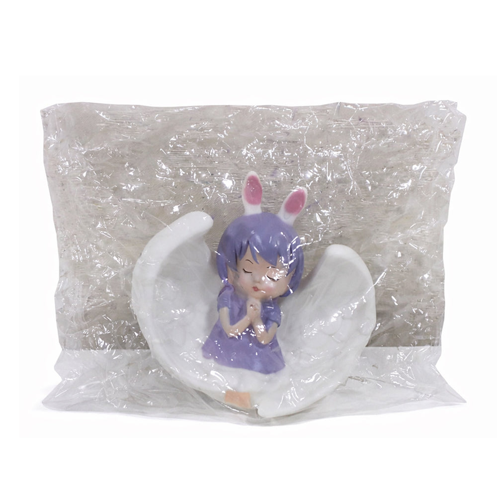 Figurine of a character with purple hair and rabbit ears inside clear plastic packaging on a white background