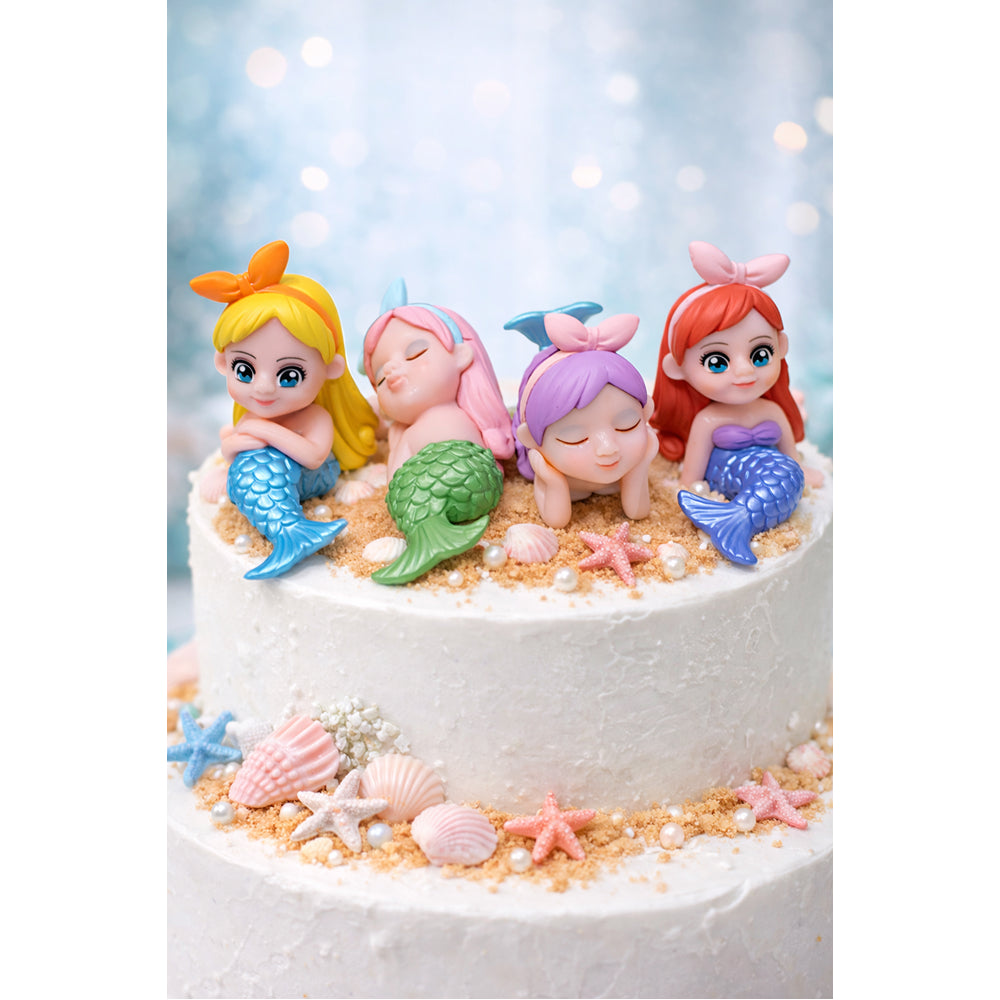 Miniatures Cake with mermaid figurines on a white background