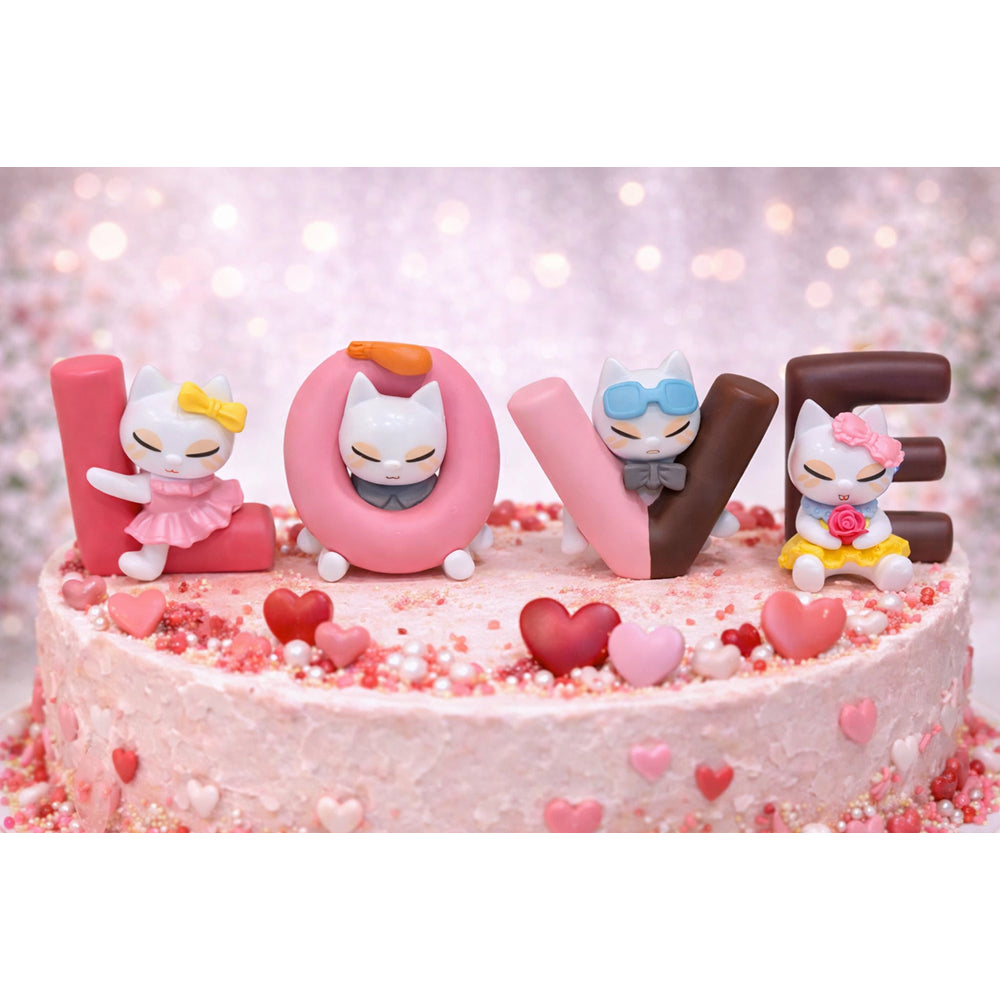 Pink cake with 'LOVE' Miniatures and cartoon cat figures on a blurred light pink background