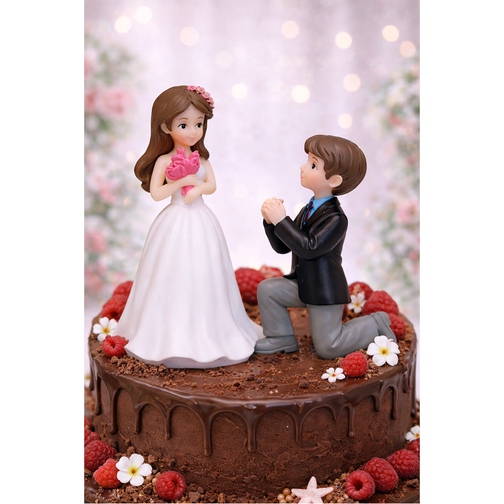 Wedding Miniatures cake topper with bride and groom figurines on a chocolate cake base.