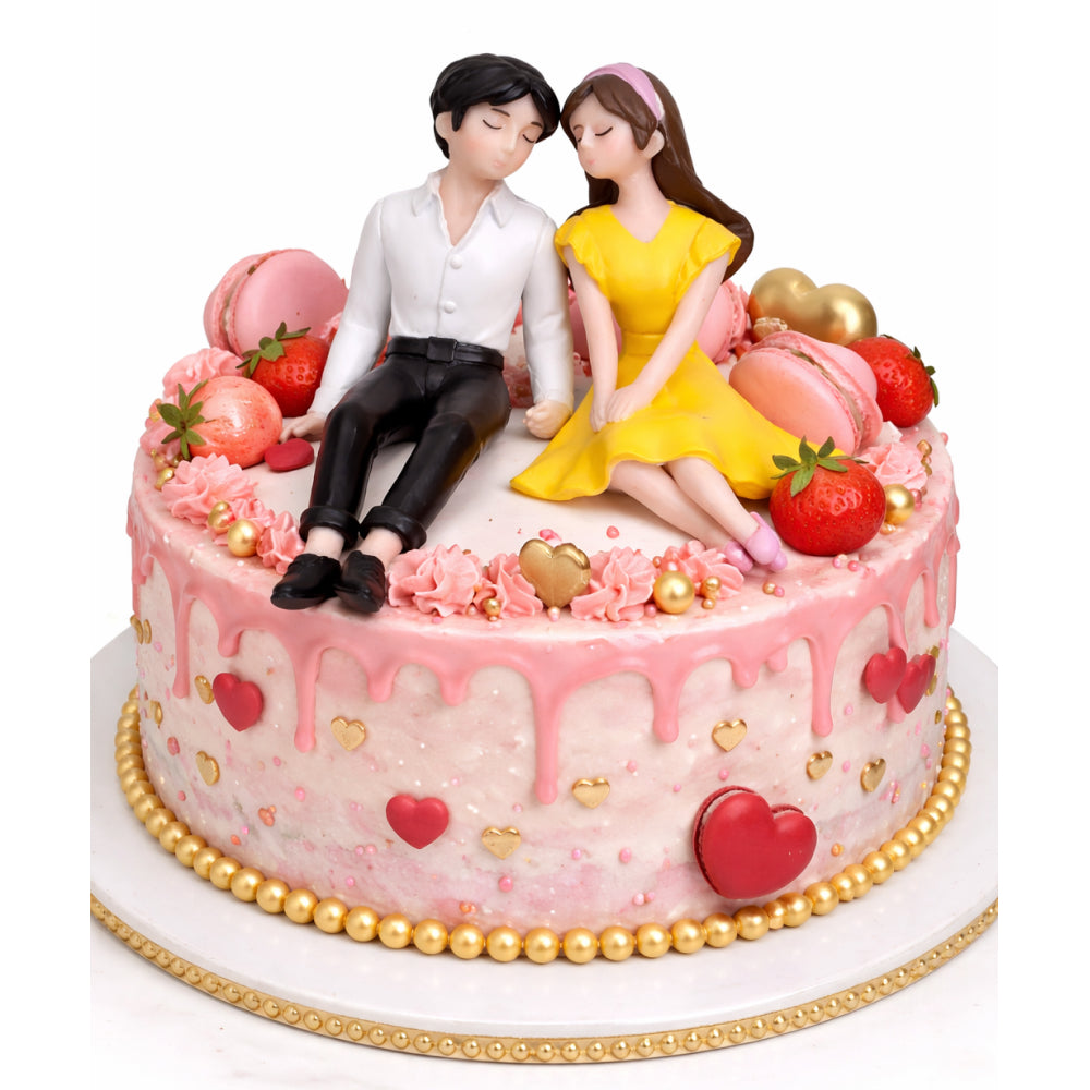 Decorative cake with Miniatures of a couple sitting together, surrounded by fruits and flowers on a white background.