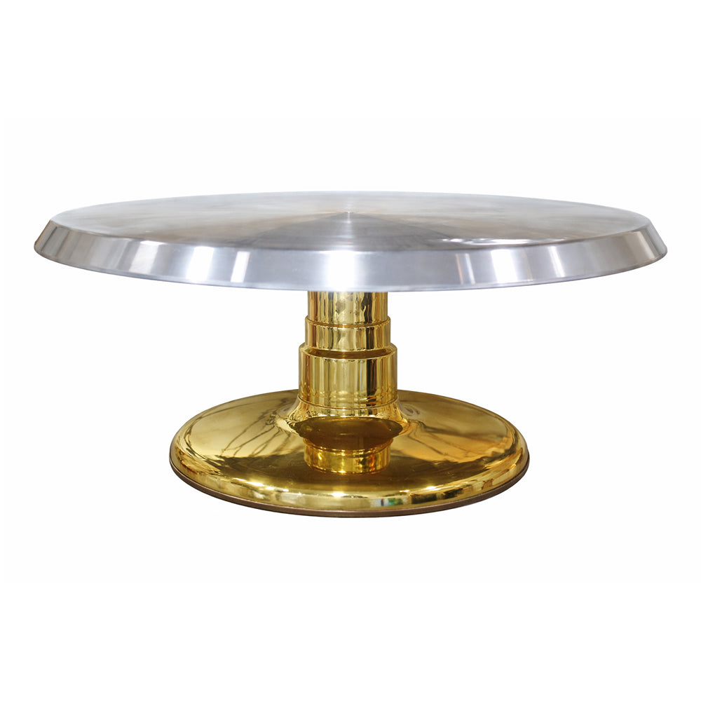 Steel cake stand with gold base and silver top on a white background