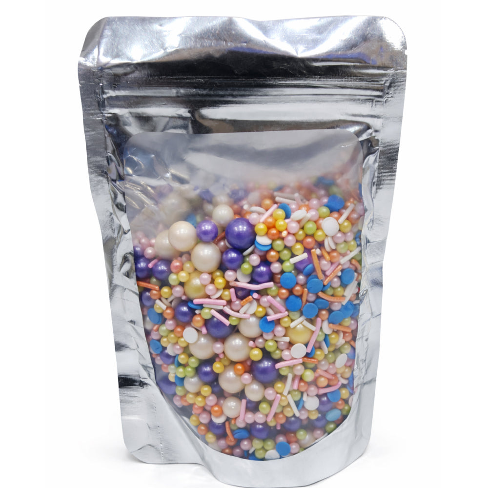 Silver stand-up pouch filled with colorful sprinkles on a white background