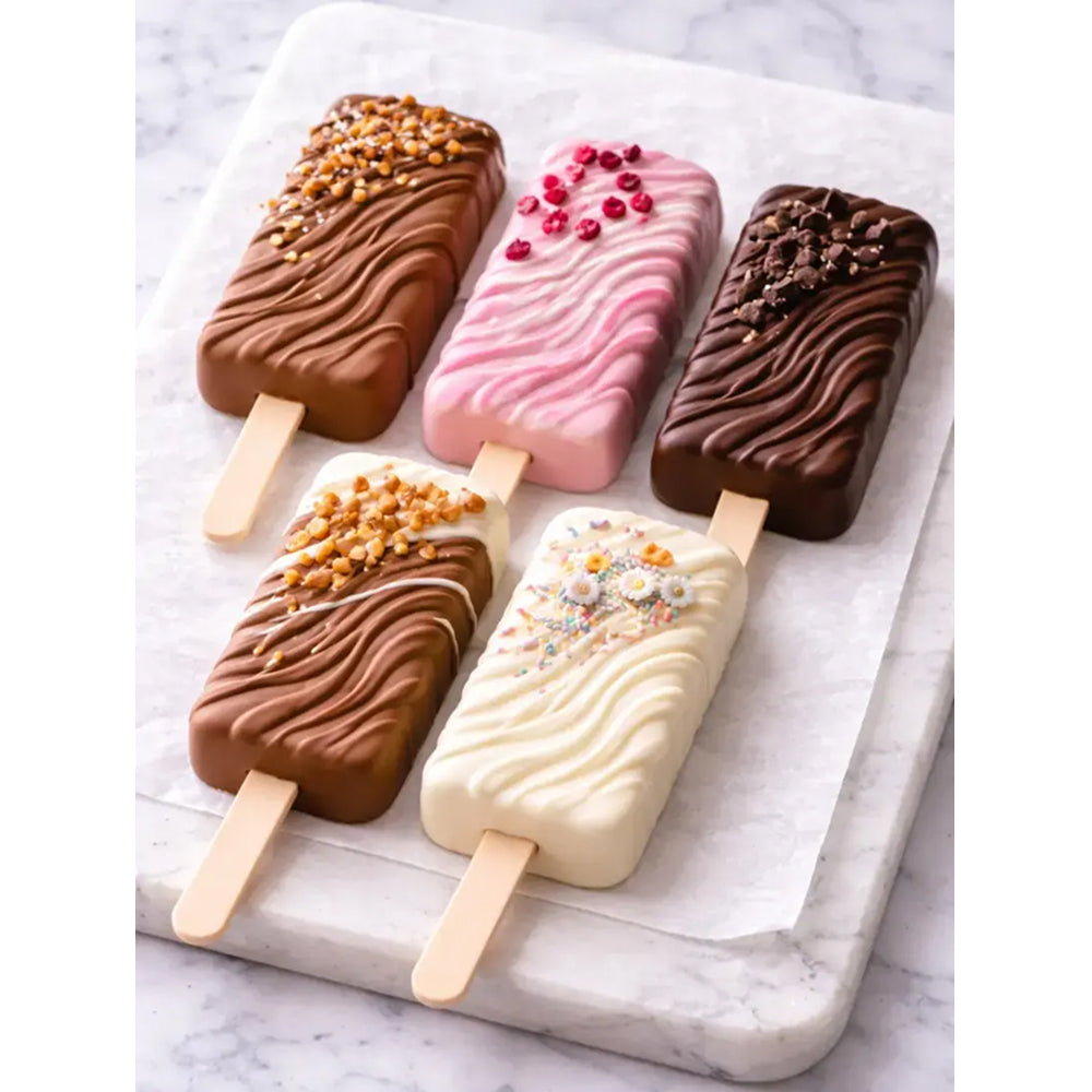 Four ice cream popsicles on a marble surface