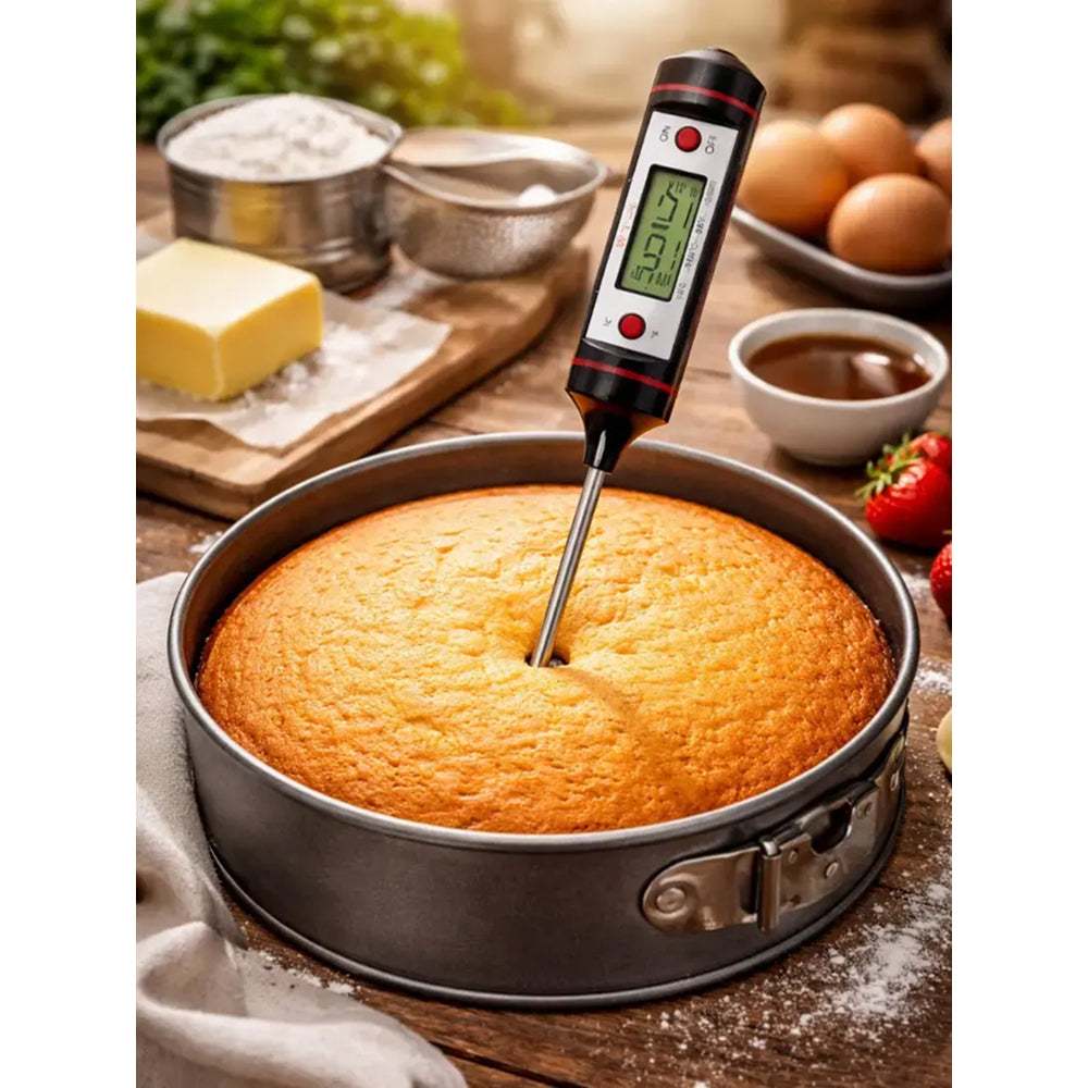 Digital thermometer inserted into a cake with baking ingredients in the background