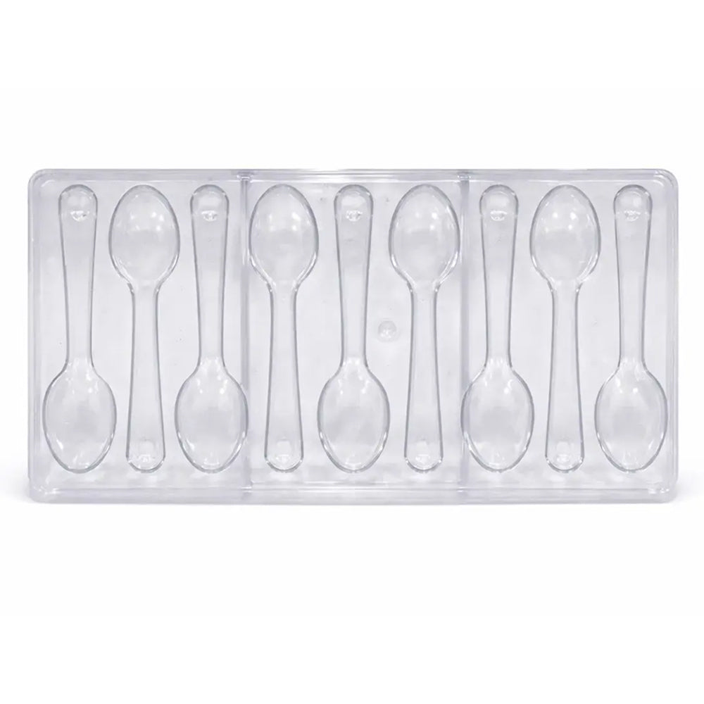 Clear Polycarbonate spoons in a mold on a white background