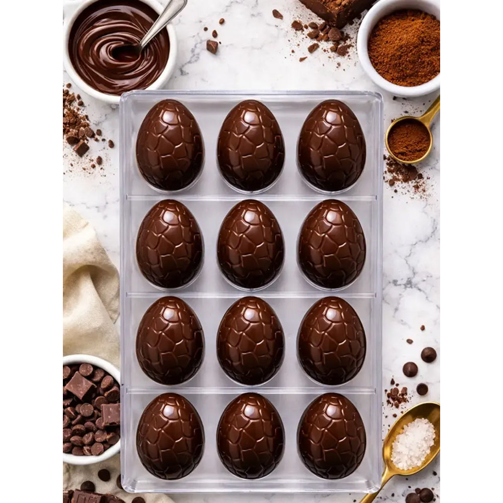 polycarbonate chocolate Easter eggs with cocoa powder and chocolate pieces on a marble surface