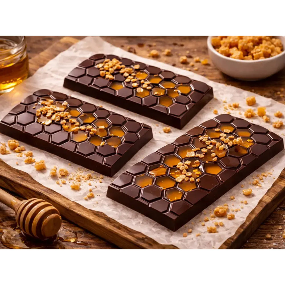 Dark chocolate bars with honeycomb and nuts on a wooden surface
