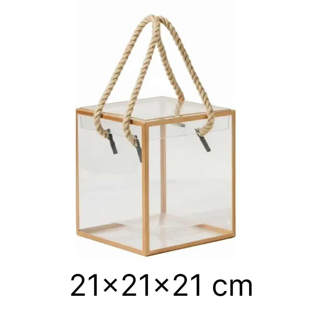 Clear square lantern with wooden frame and rope handle on a white background
