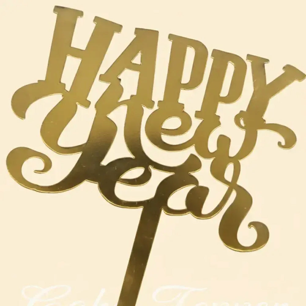 Gold 'Happy New Year' cake topper on a beige background