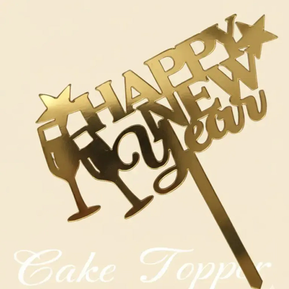 Gold 'Happy New Year' cake topper with champagne glass design on a beige background