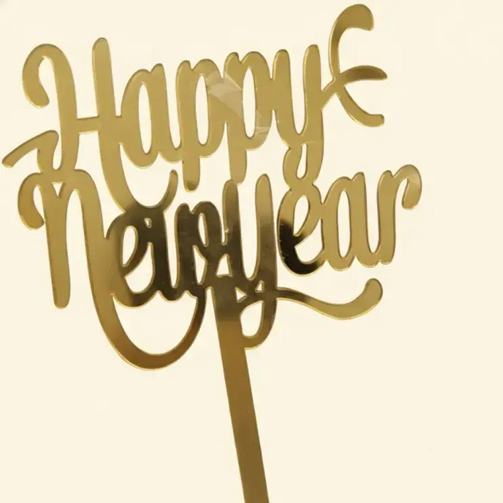 Gold 'Happy New Year' cake topper on a beige background