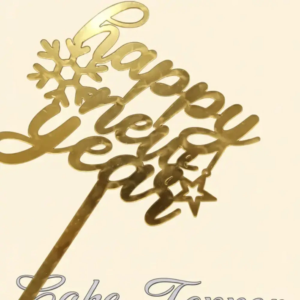 Gold 'Happy New Year' cake topper on a beige background
