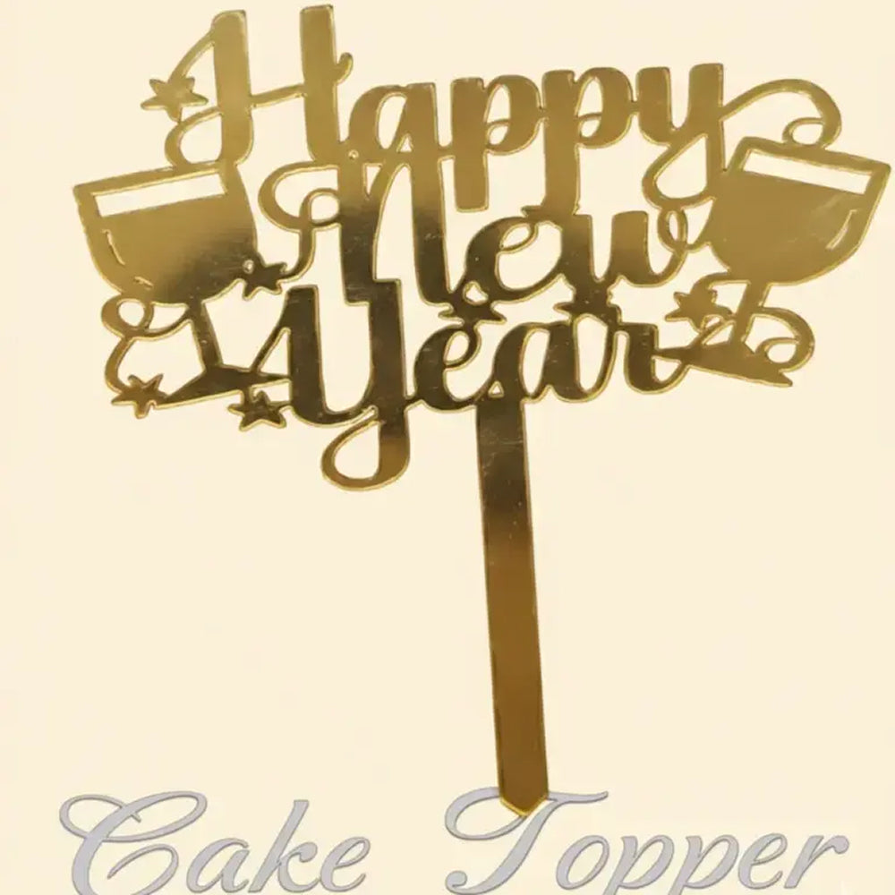 Gold 'Happy New Year' cake topper on a beige background