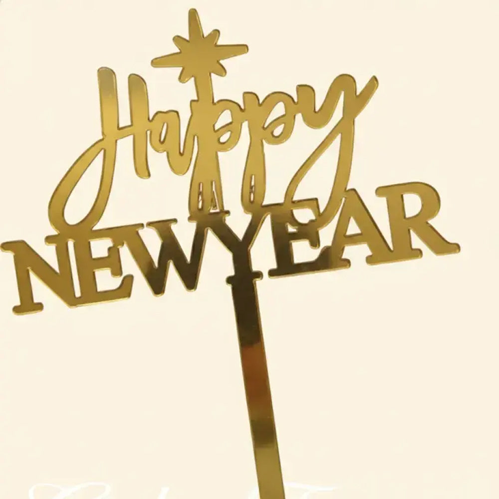 Gold 'Happy New Year' cake topper on a beige background