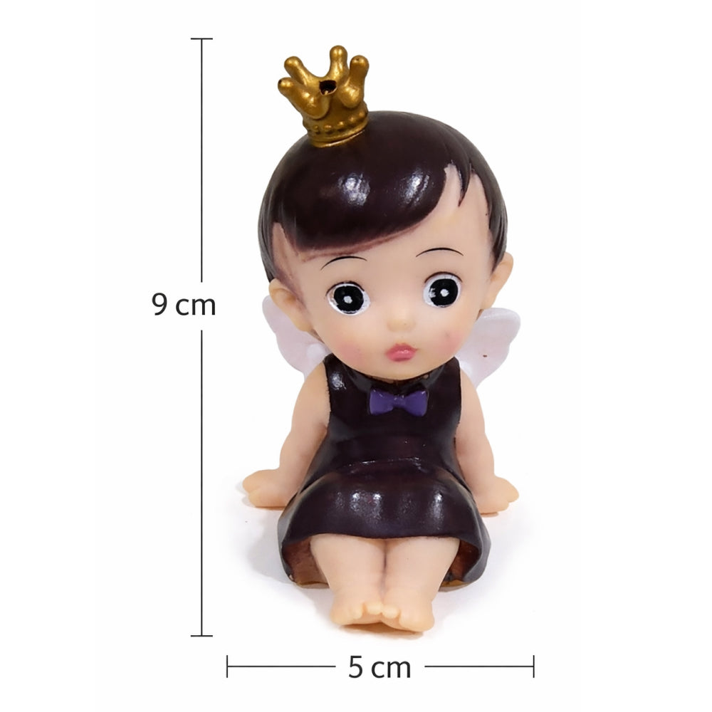Small figurine of a baby with a crown and dress, shown with measurements on a white background.