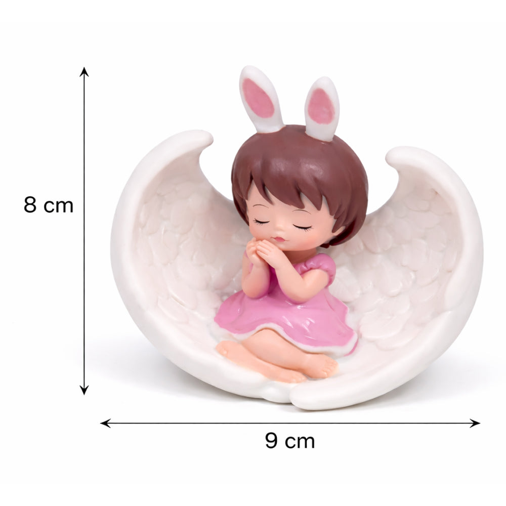 Figurine of a girl with bunny ears sitting on a moon, with measurements indicated.