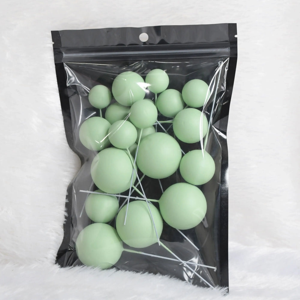 Green matte faux balls in assorted sizes sealed inside a transparent zip-lock packet – ideal for modern cake decoration or DIY crafts
