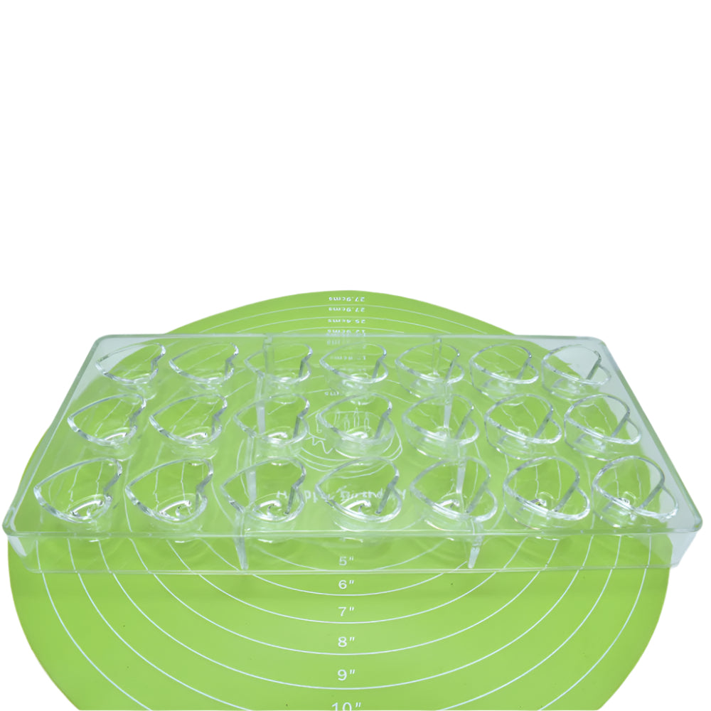Heart Shaped Polycarbonate Chocolate Mold placed on a green baking mat against a white background for a detailed view.
