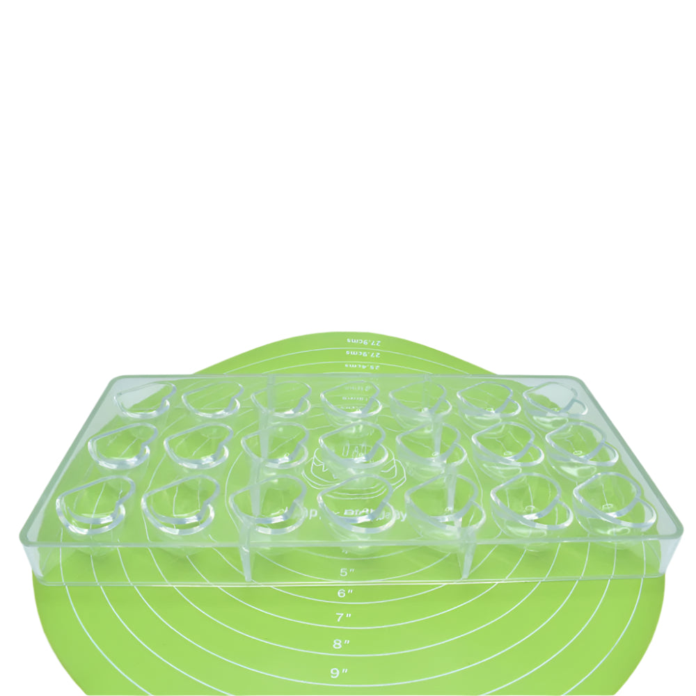 Heart Shaped Polycarbonate Chocolate Mold placed on a green baking mat against a white background for a detailed view.