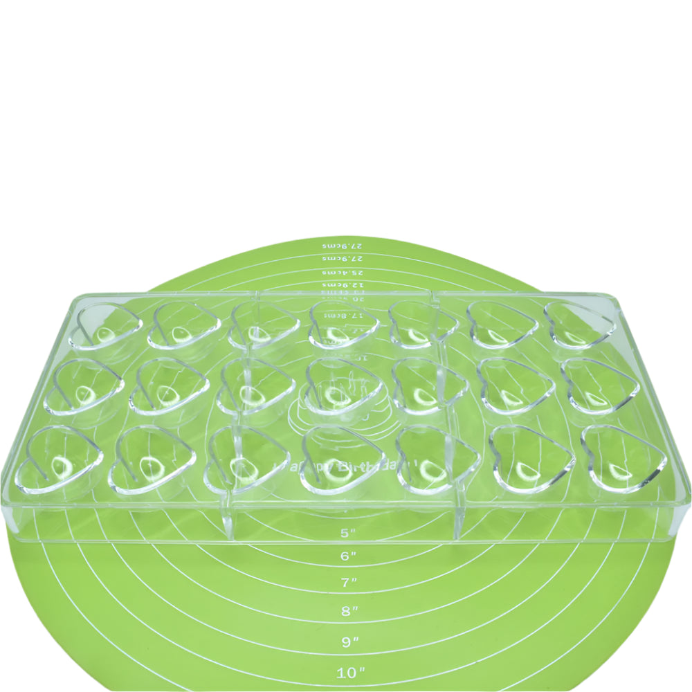 Heart Shaped Polycarbonate Chocolate Mold placed on a green baking mat against a white background for a detailed view.
