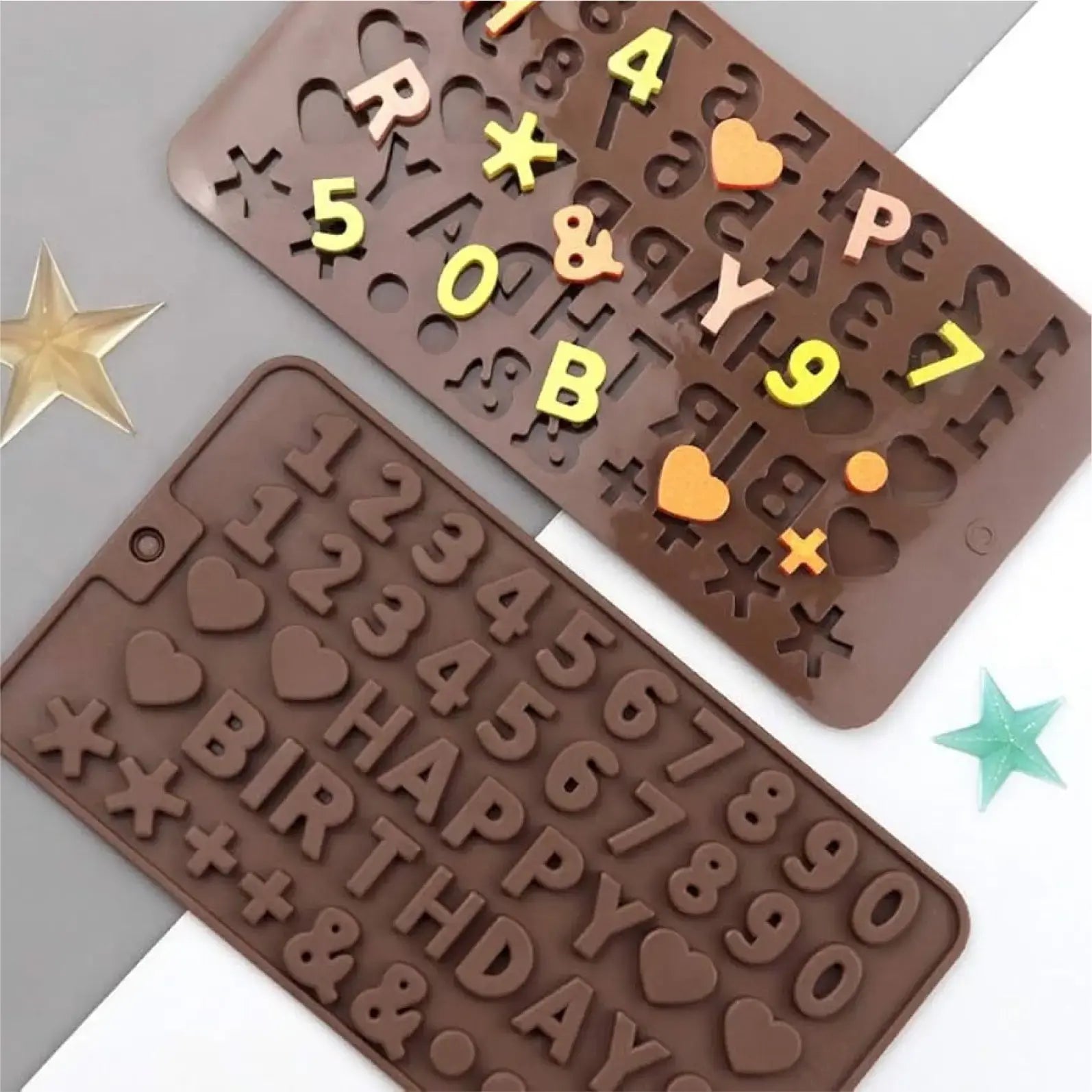 Chocolate mold with letters, numbers, and symbols on a gray background