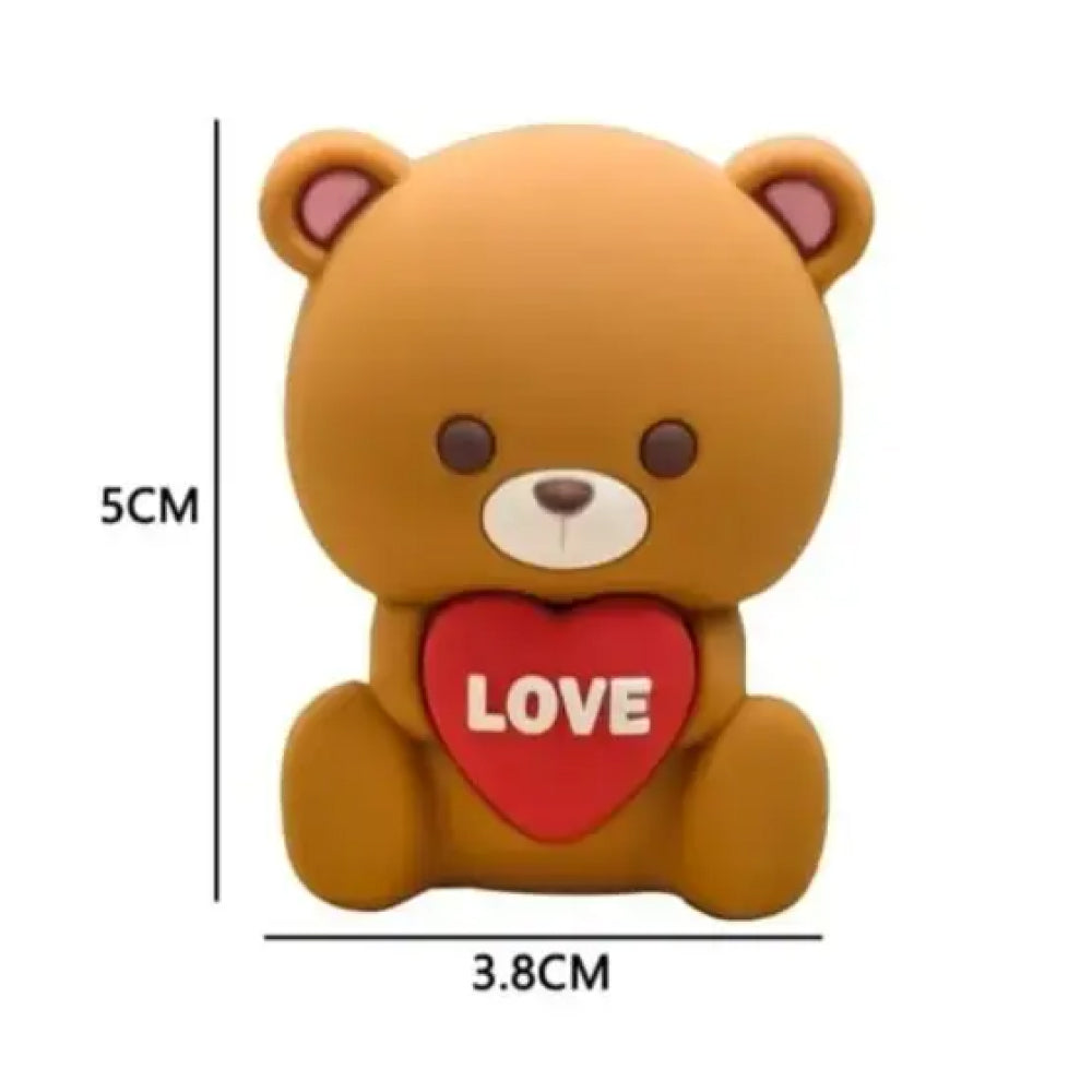 Miniature 5cm tall and 3.8cm wide teddy bear cake topper in a seated position, featuring soft brown tones, rounded pink-accented ears, and a big red heart marked with “LOVE” – perfect for decorating cupcakes, anniversary cakes, and romantic celebration themes with a cute and cuddly vibe