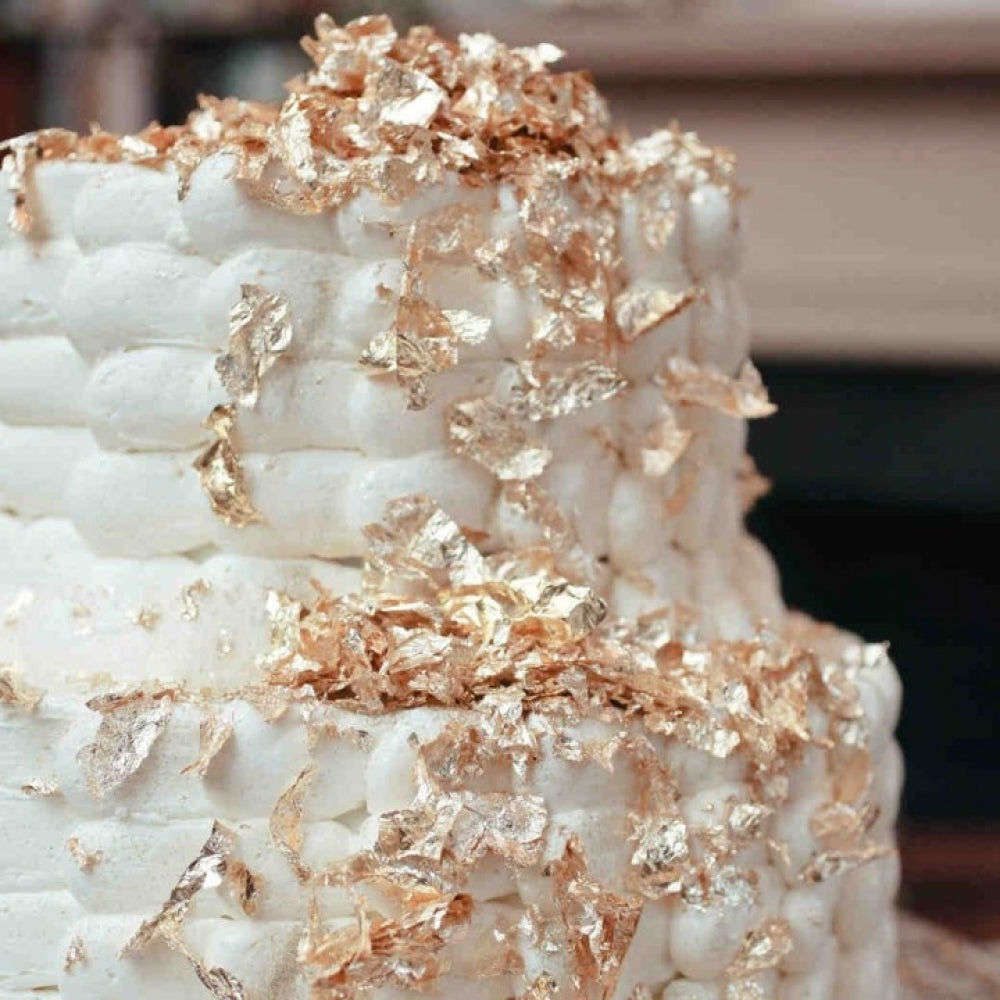 Non-Edible Golden Flakes in use, demonstrating their application on cakes and desserts for a luxurious finish.