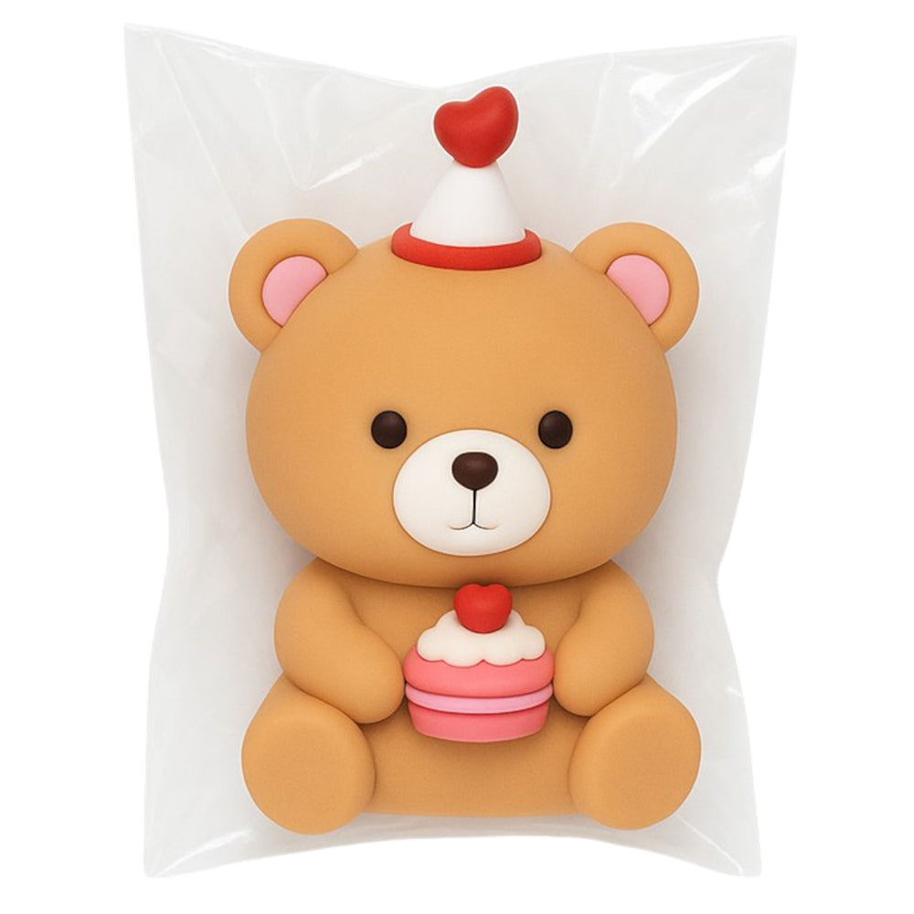 Adorable brown teddy bear cake topper miniature sealed in transparent plastic packaging, featuring a cute white and red party hat with a heart top, pink inner ears, and a detailed pink cupcake with white frosting and red cherry, perfect for kids’ birthday cakes, Valentine’s Day bakes, or cute-themed party decorations