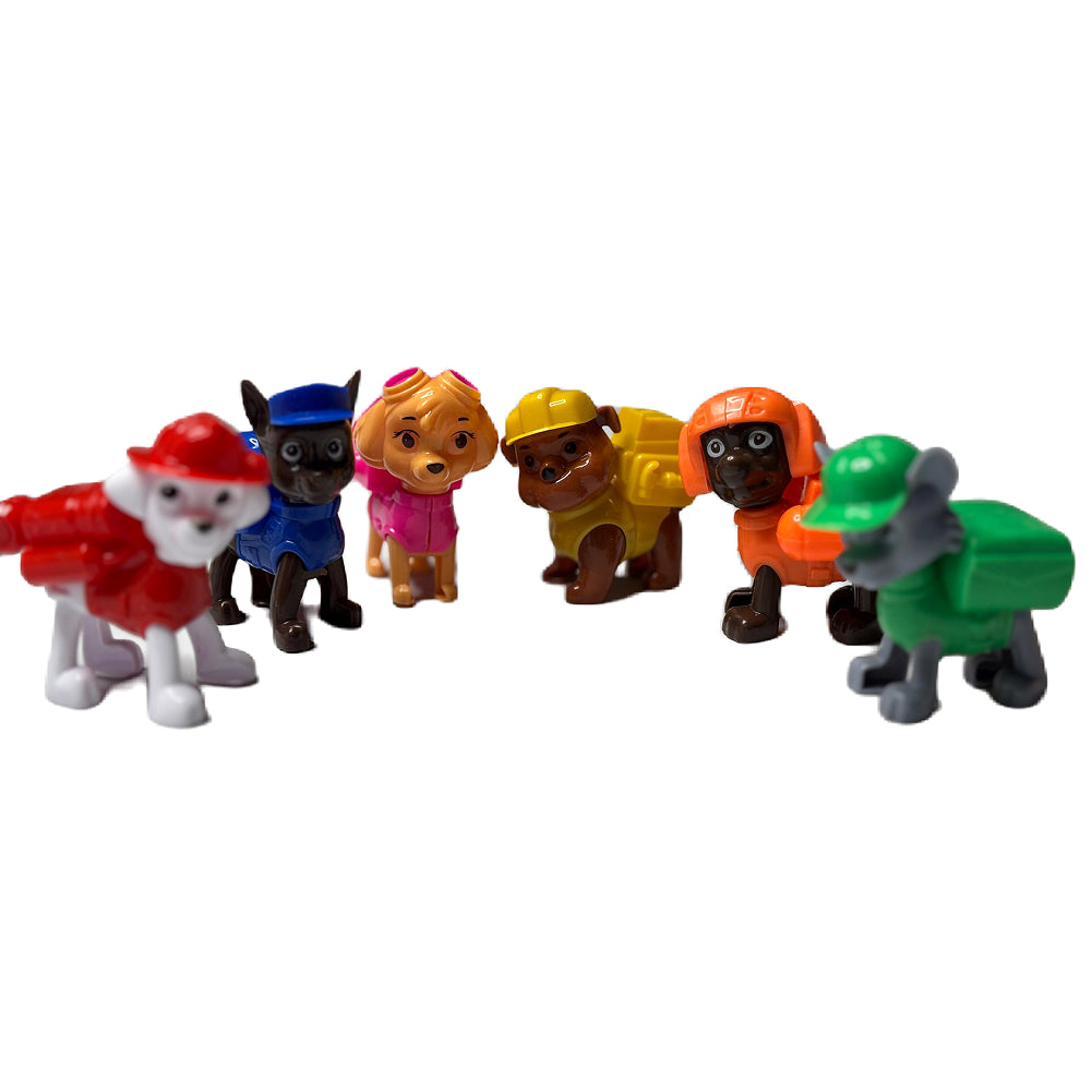 Close-up of 6 Paw Patrol Toy Cake Toppers arranged on white background