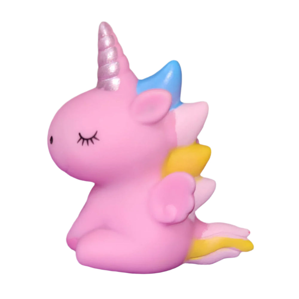 Close-up of Small Cute Unicorn Cake Toy Topper on white background