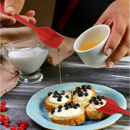 Image demonstrates the Ultra Big Silicone Spatula in use, mixing batter in a glass bowl, showcasing its versatility and functionality.