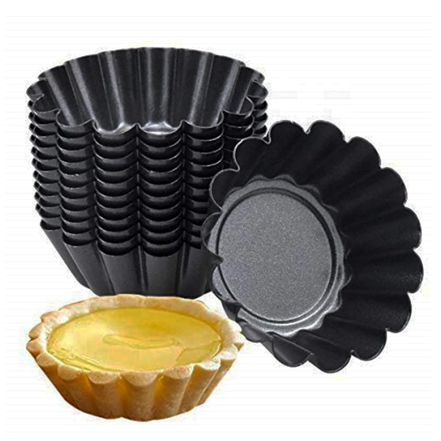 Set of black tart tins with a filled tart on a white background