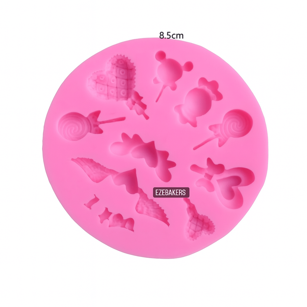 Pink silicone mold with various shapes on a white background