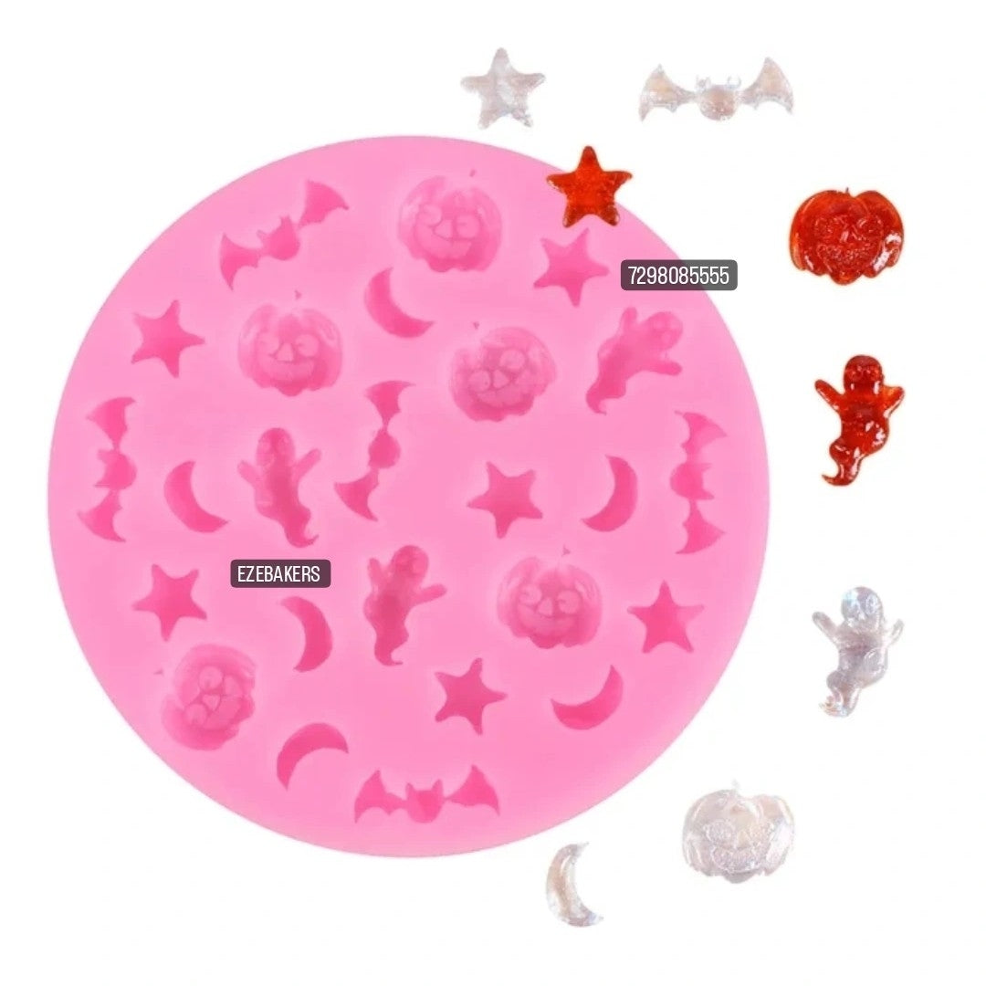 Pink silicone mold with various shapes on a white background