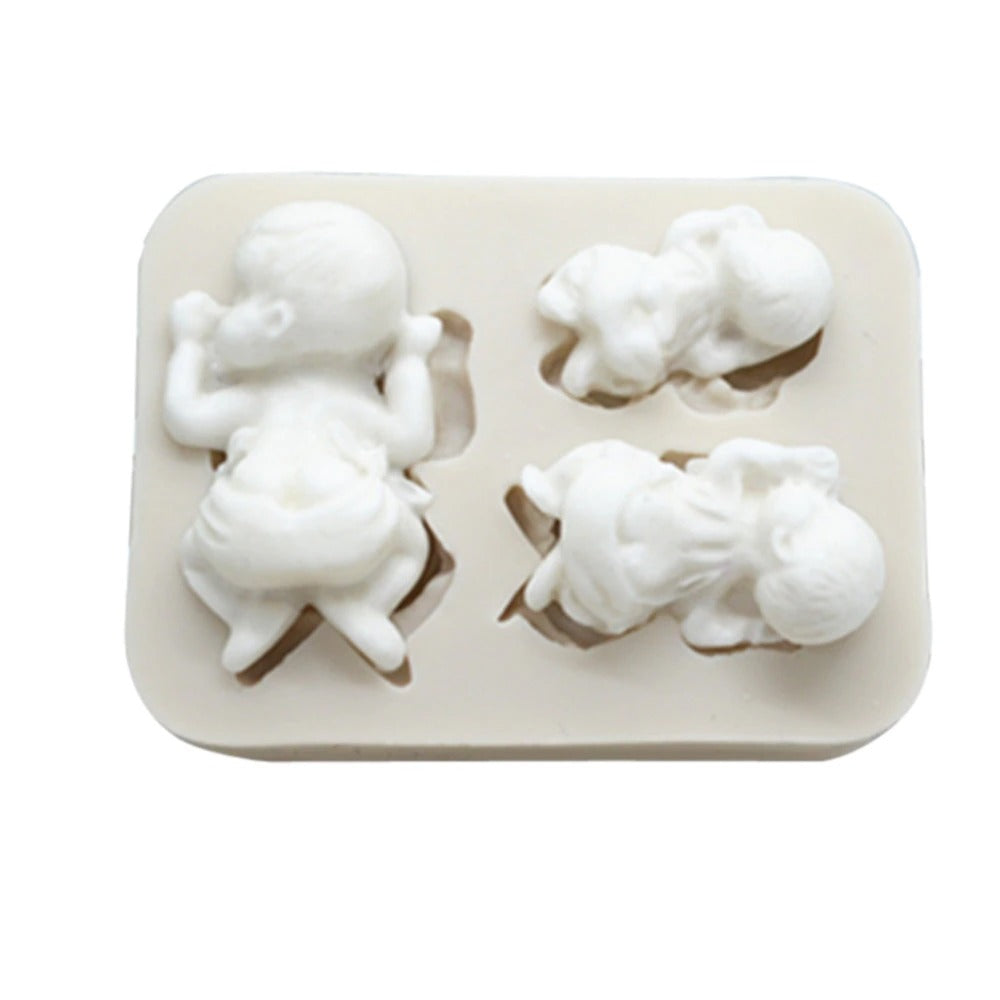 Silicone mold with three-dimensional baby shapes on a fondant mold