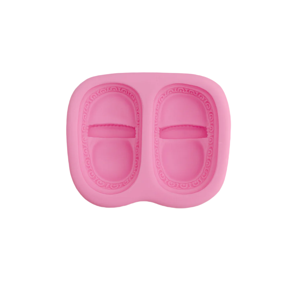 Pink silicone fondant mold for making candy or chocolate on a light gray background