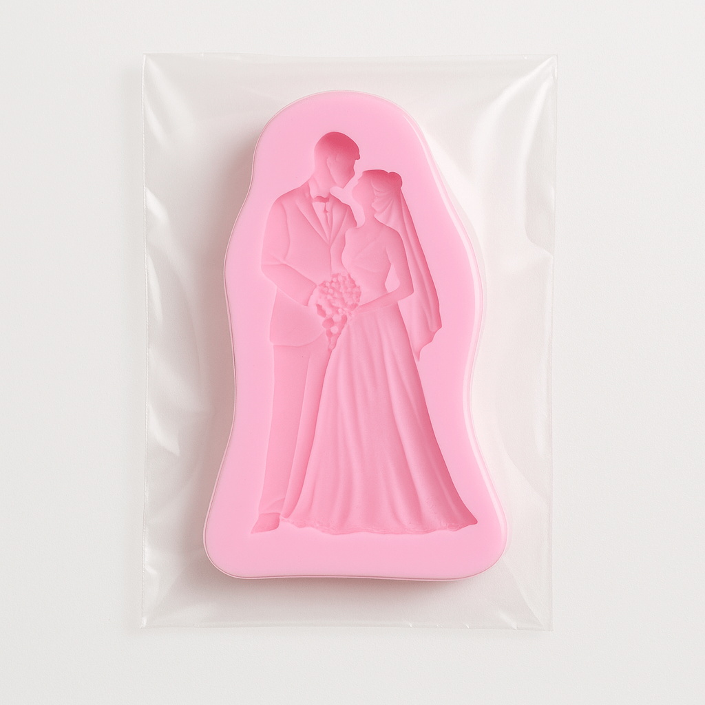 Pink silicone fondant mold of a bride and groom in a clear packaging on a white background