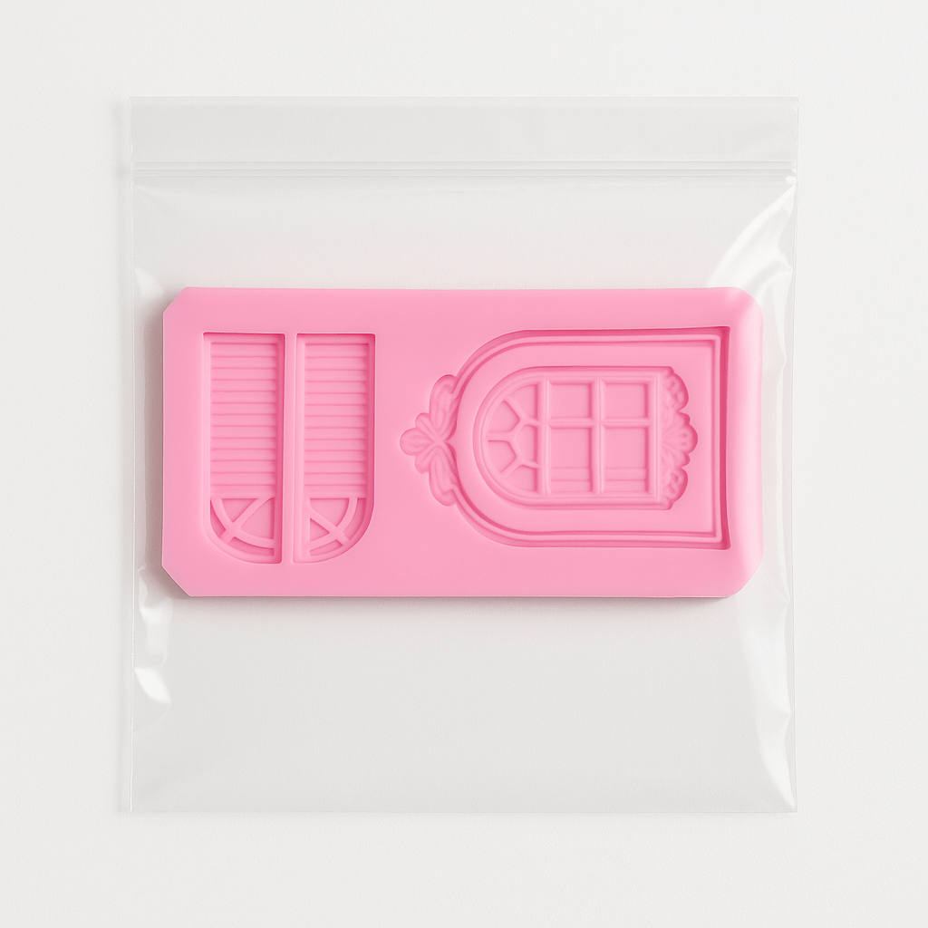 Pink silicone fondant mold with a door and window design in it's packet on a white background