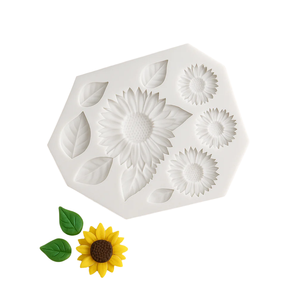 White silicone fondant mold with sunflower design on a light surface with decorative sunflower and leaves