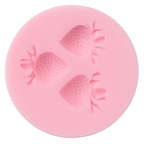 Pink silicone mold with strawberry shapes on a white background