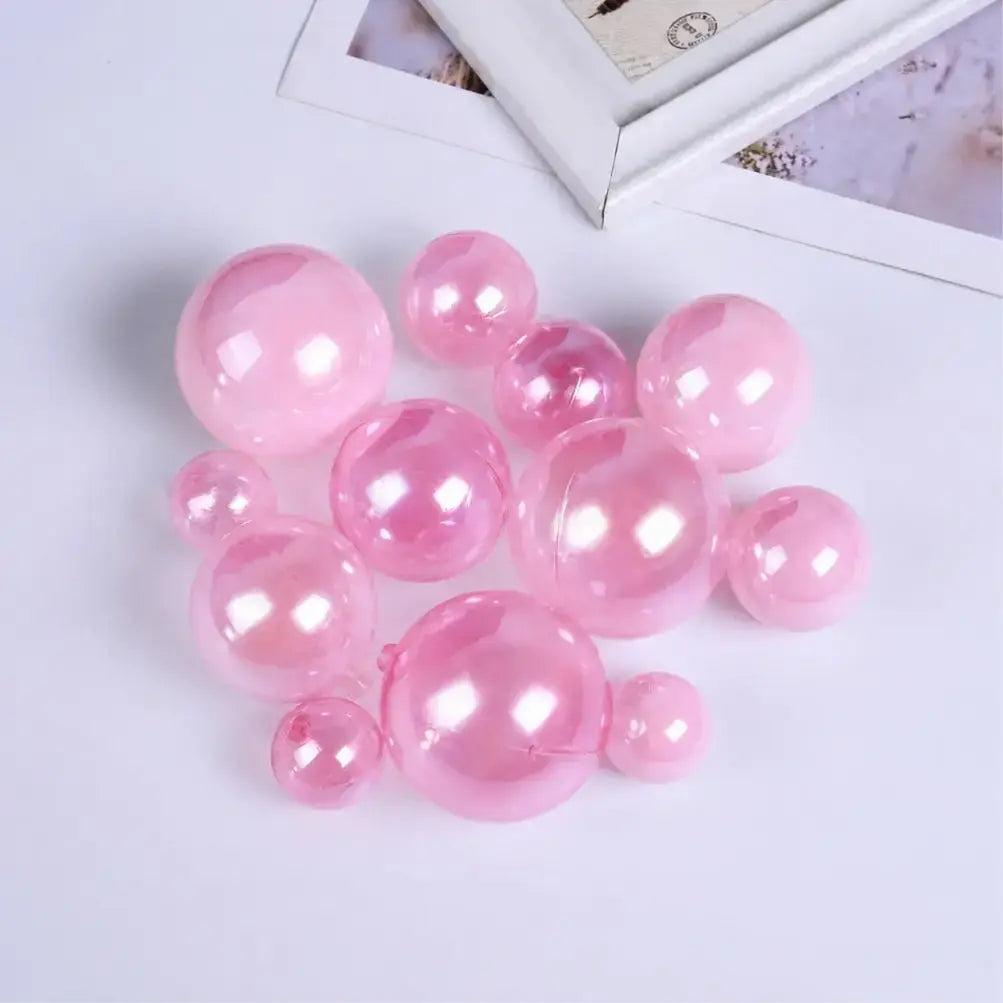 Pink Plastic Faux ball on a light purple surface with a blurred photo frame in the background