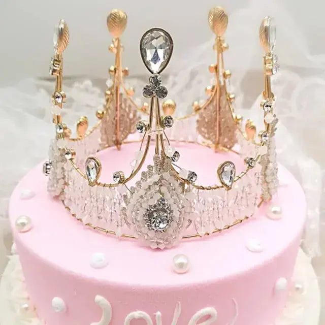Decorative crown cake topper on a pink cake with 'love' text. To display its real use