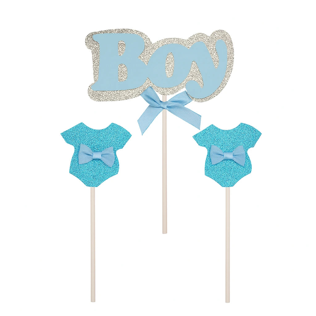 Decorative cake toppers with 'Boy' text, baby onesies, and a bow tie on sticks against a white background.