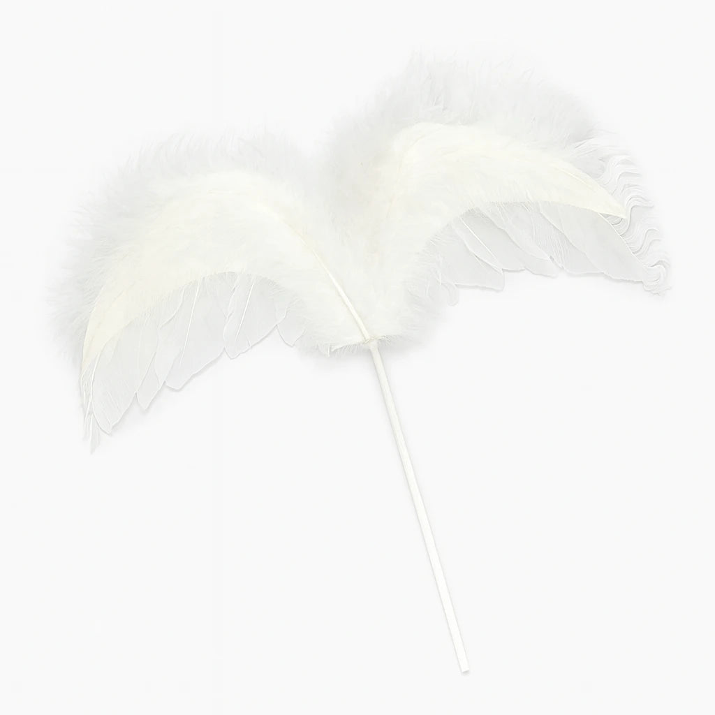 White feather wings cake topper on a white background
