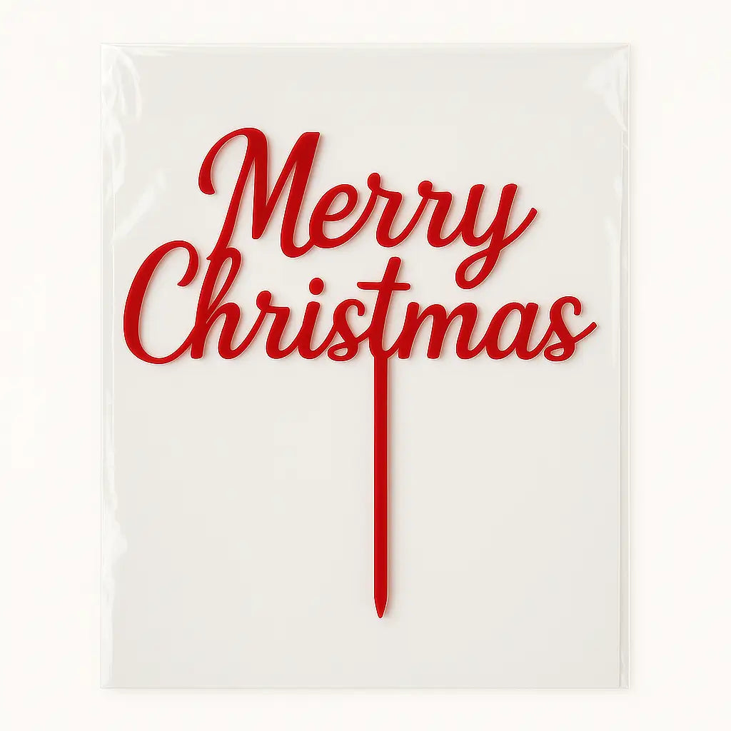 Red 'Merry Christmas' cake topper in its packets on a white background
